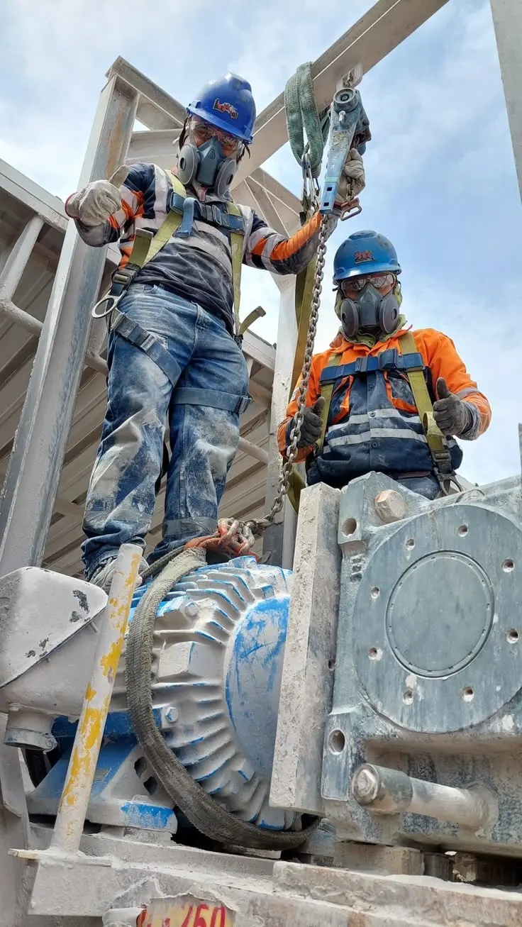 Crew members working together on deck equipment